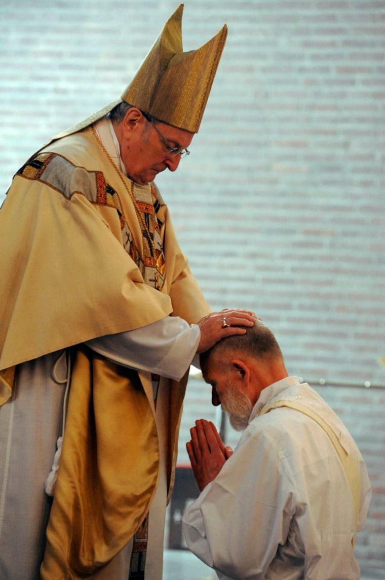 Image: German Archbishop of Cologne Joachim Cardinal Meisner, left, ordains Harm Klueting during a ceremony at the Roman Catholic priests college in Cologne
